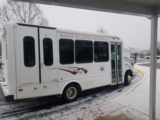 A white bus parked in a snowy environment, showcasing winter weather conditions.