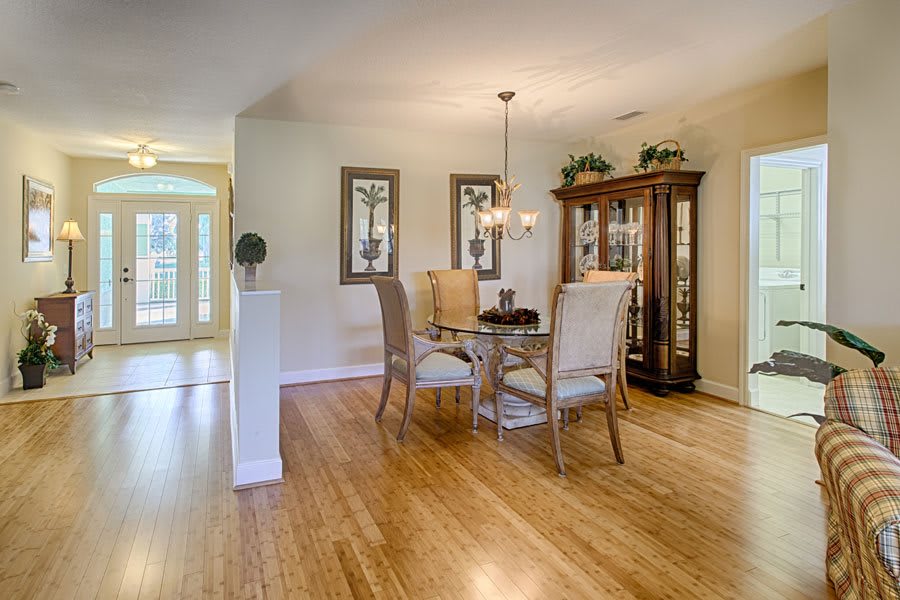 A cozy dining area with a wooden table and chairs, complemented by elegant dcor and a chandelier.