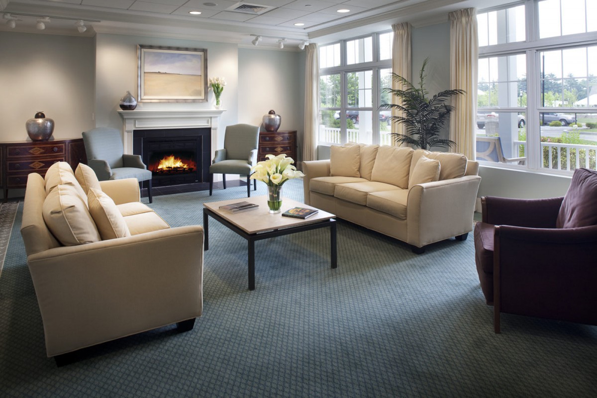 Cozy living room with sofas and a fireplace.