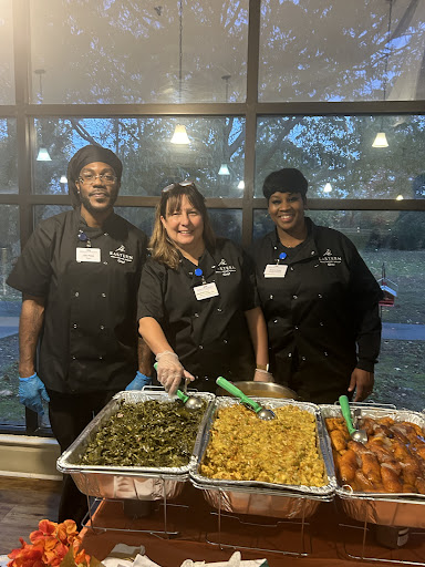 Dedicated volunteers serving delicious dishes at a community event.