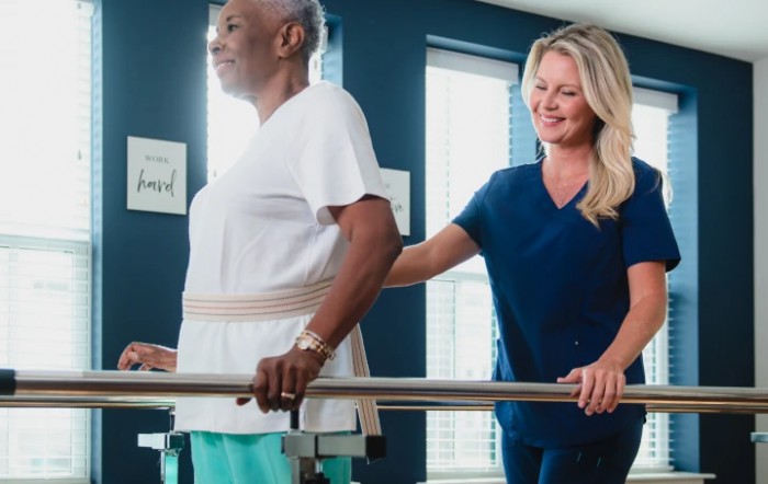 A physical therapist assisting a patient during a rehabilitation session.