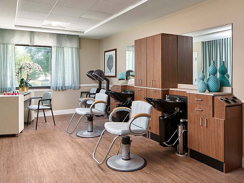 A well-lit and organized hair salon with modern furnishings and equipment.