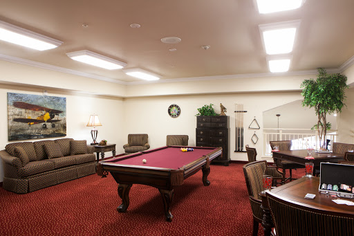 A cozy game room featuring a pool table, comfortable seating, and a welcoming atmosphere.