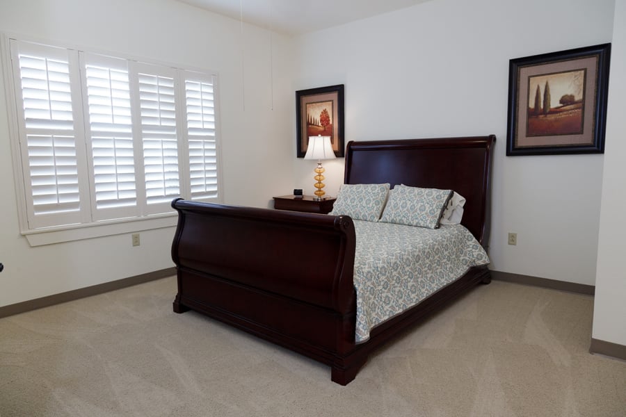 A cozy bedroom with a wooden sleigh bed and elegant decor.