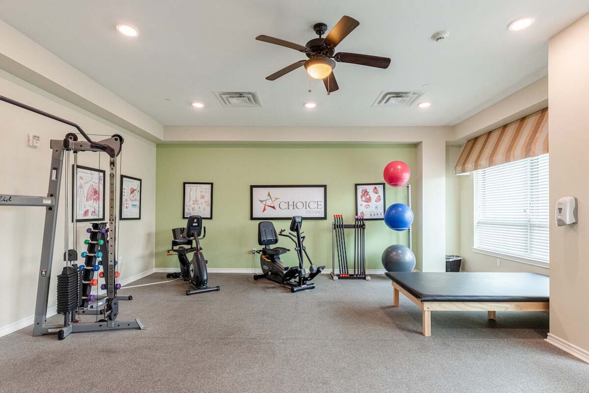 A well-equipped indoor gym with exercise machines and a training area.