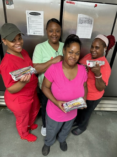 A dedicated team proudly showcasing their culinary creations.