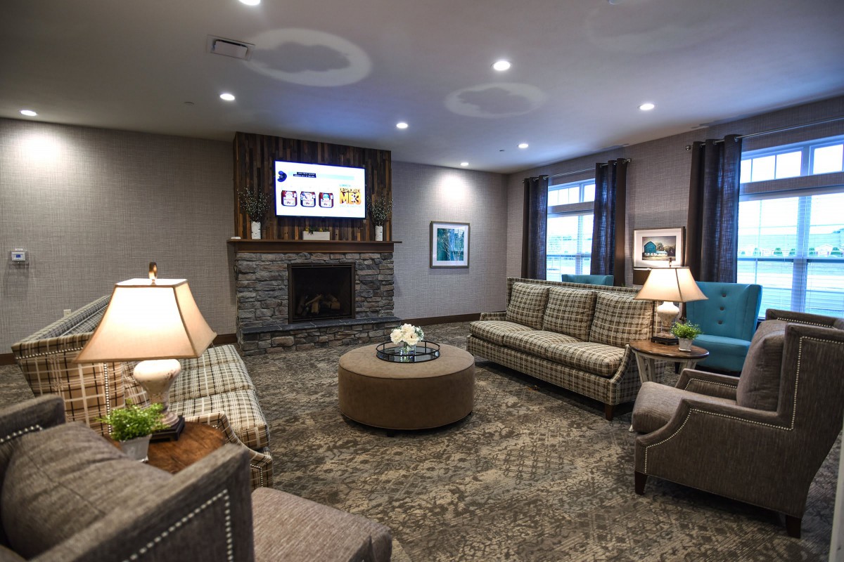 A cozy living room with comfortable seating and a fireplace.