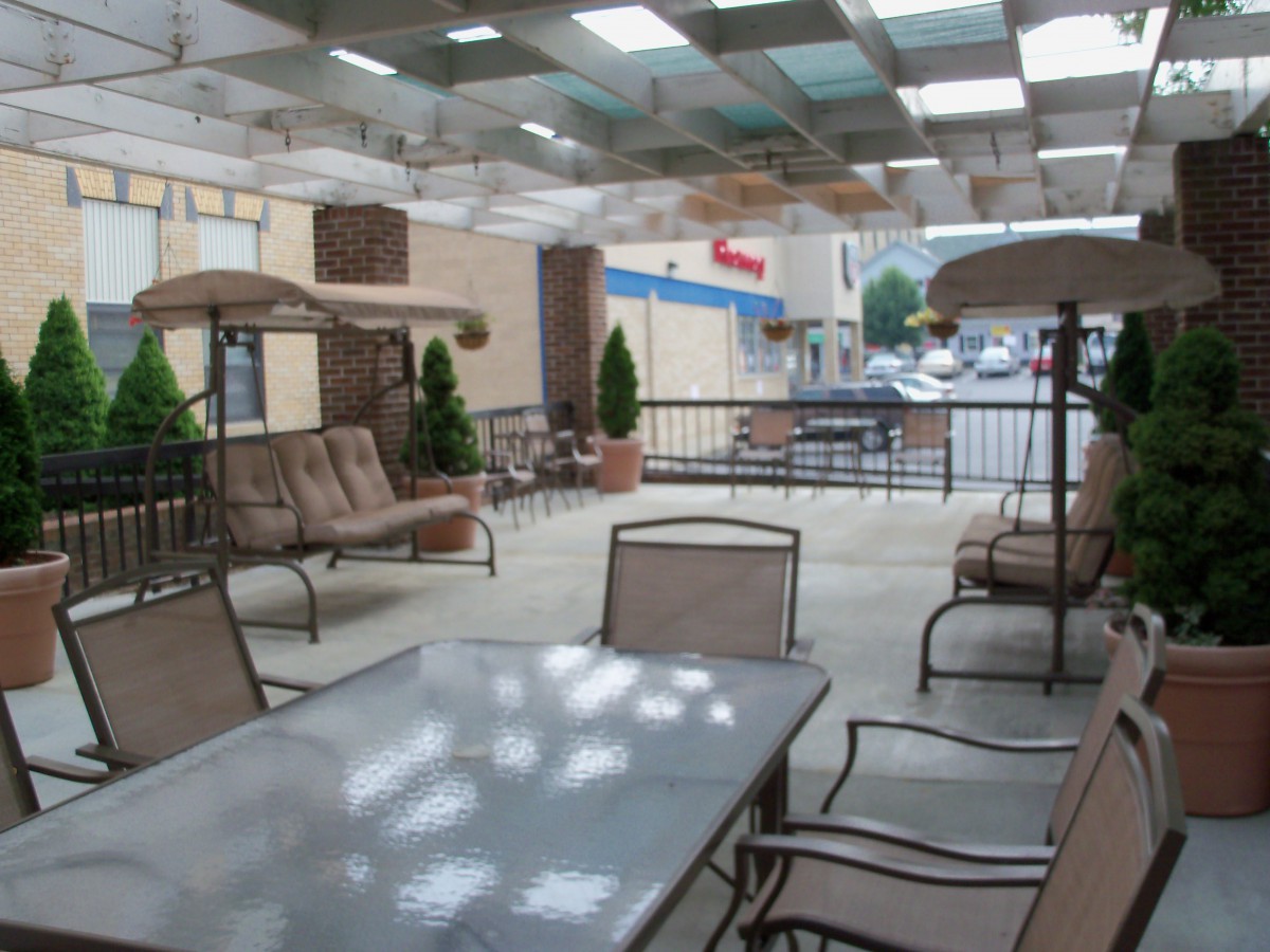 A covered outdoor patio with tables and seating for relaxation.