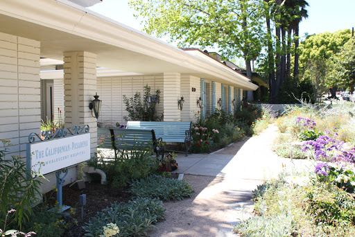A charming residential setting with well-maintained gardens and a welcoming pathway.