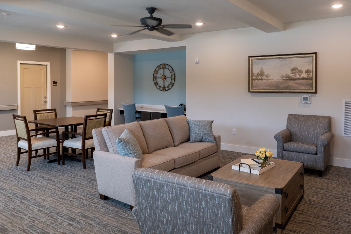 A modern living room with a cozy seating arrangement and adjoining dining area.