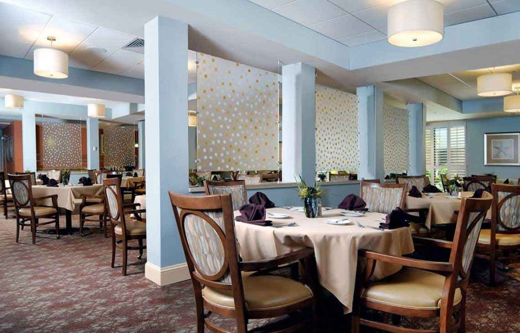 An elegant restaurant dining area with neatly arranged tables and chairs.