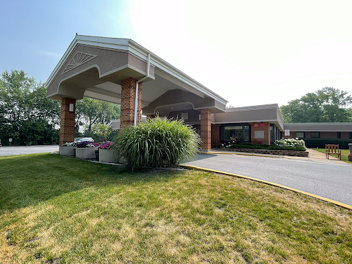 A welcoming entrance to a well-designed building with a manicured lawn.