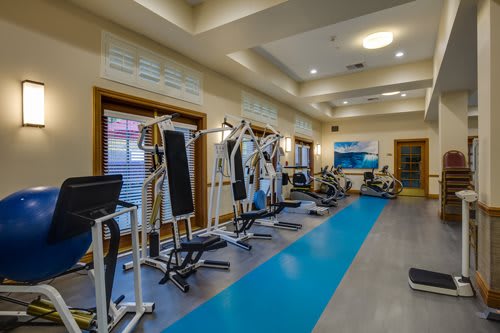 A well-equipped gym with various exercise machines and a clean, inviting atmosphere.