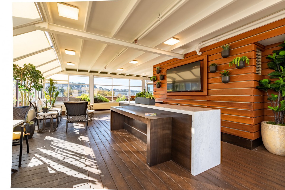 A modern outdoor patio with stylish furnishings and abundant natural light.
