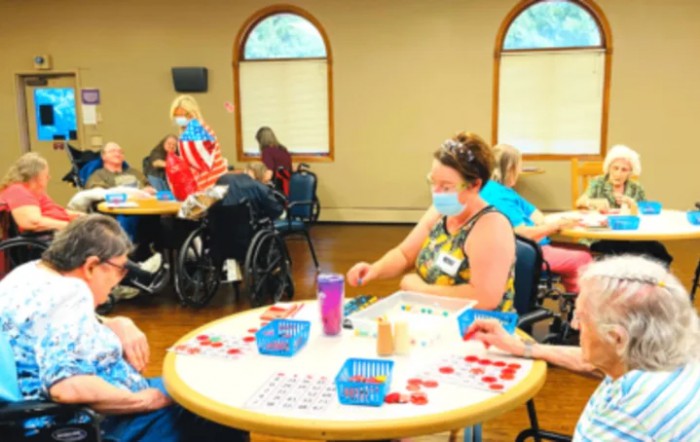 A group of people enjoying a game of bingo in a community center.