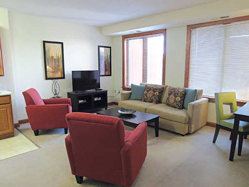 A cozy living room setup featuring comfortable seating and a television.