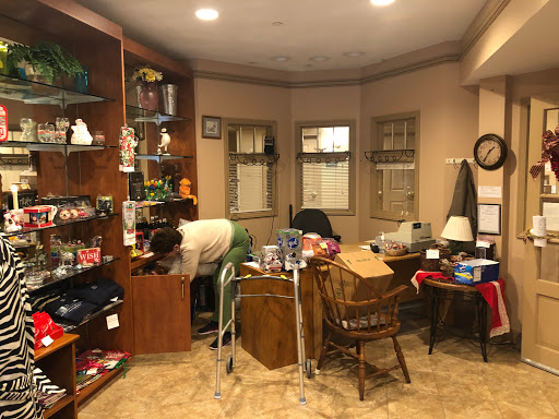 A cozy but cluttered room filled with various items and furniture.