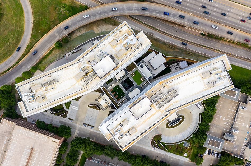 Aerial view of a modern architectural complex surrounded by roads.