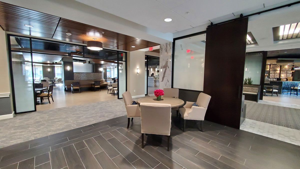 A modern office reception area with a round table and chairs.