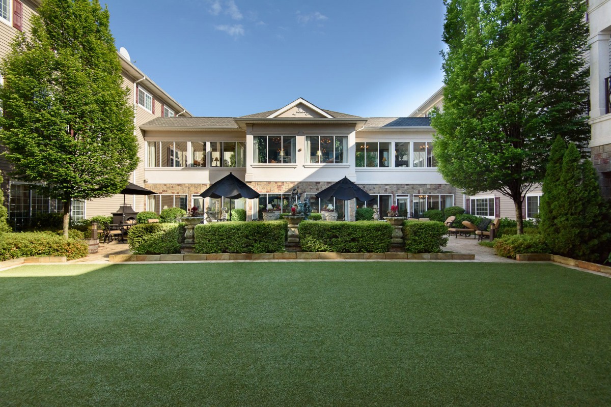 Beautiful two-story house with a well-maintained lawn and garden.