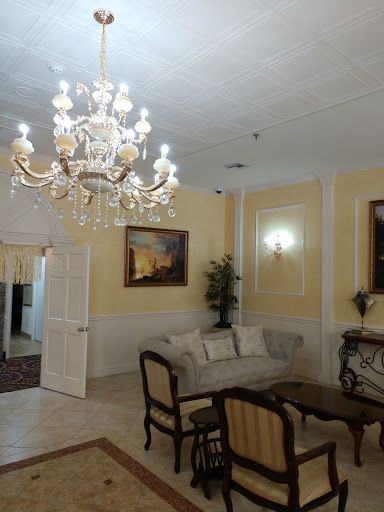 A beautifully decorated living room featuring a luxurious chandelier and elegant furniture.