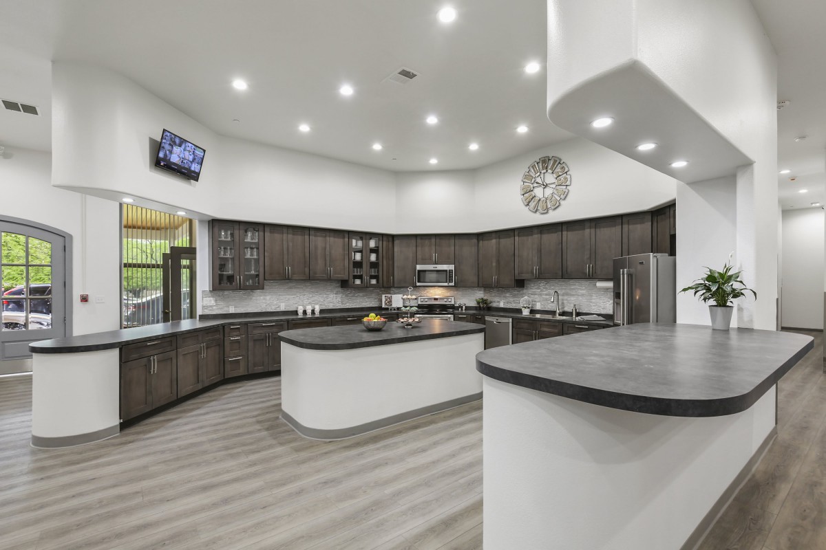 A spacious, modern kitchen with a central island and sleek design elements.