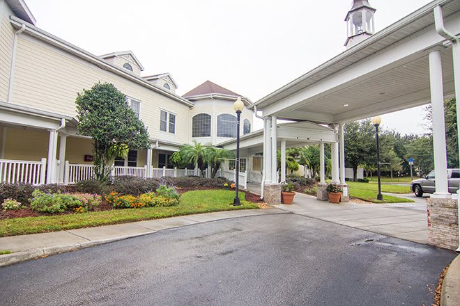 A welcoming entrance to a large building with well-maintained landscaping.