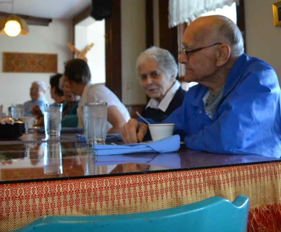 Senior adults enjoying a meal together in a restaurant.