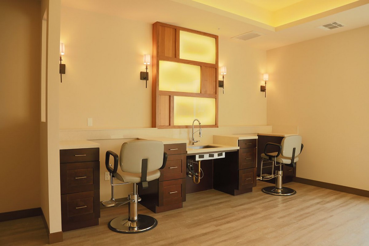 A modern hair salon interior with styling stations and comfortable chairs.