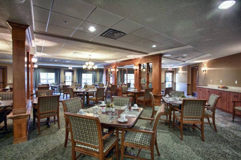 A well-arranged dining room with tables and chairs set for guests.