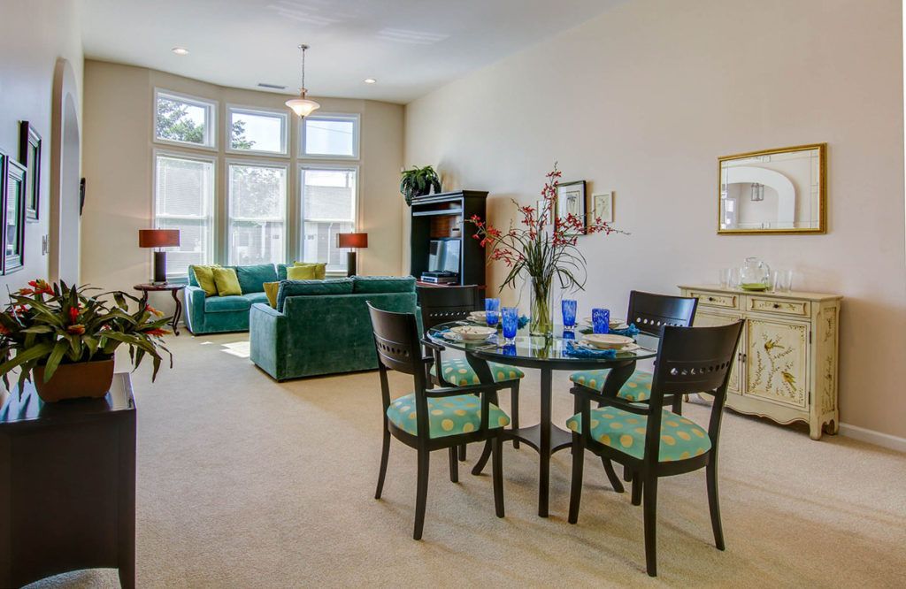 A bright and modern open-concept living room and dining area with chic furniture and decor.