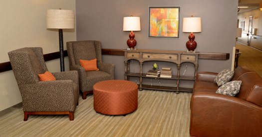 A cozy living room with comfortable seating and warm lighting.