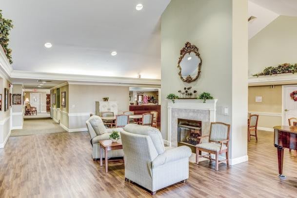 A cozy living room with comfortable seating, a fireplace, and elegant decor.