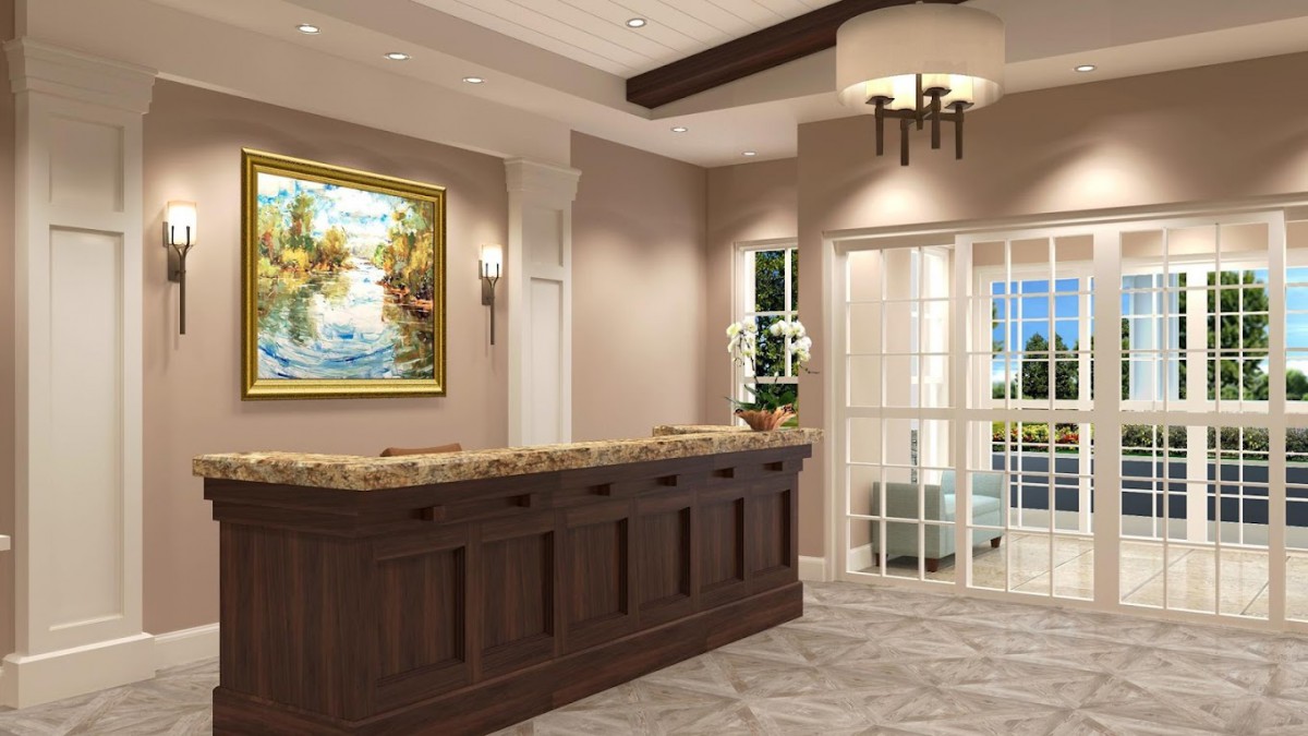 A modern reception area with a wooden desk, elegant lighting, and framed artwork.
