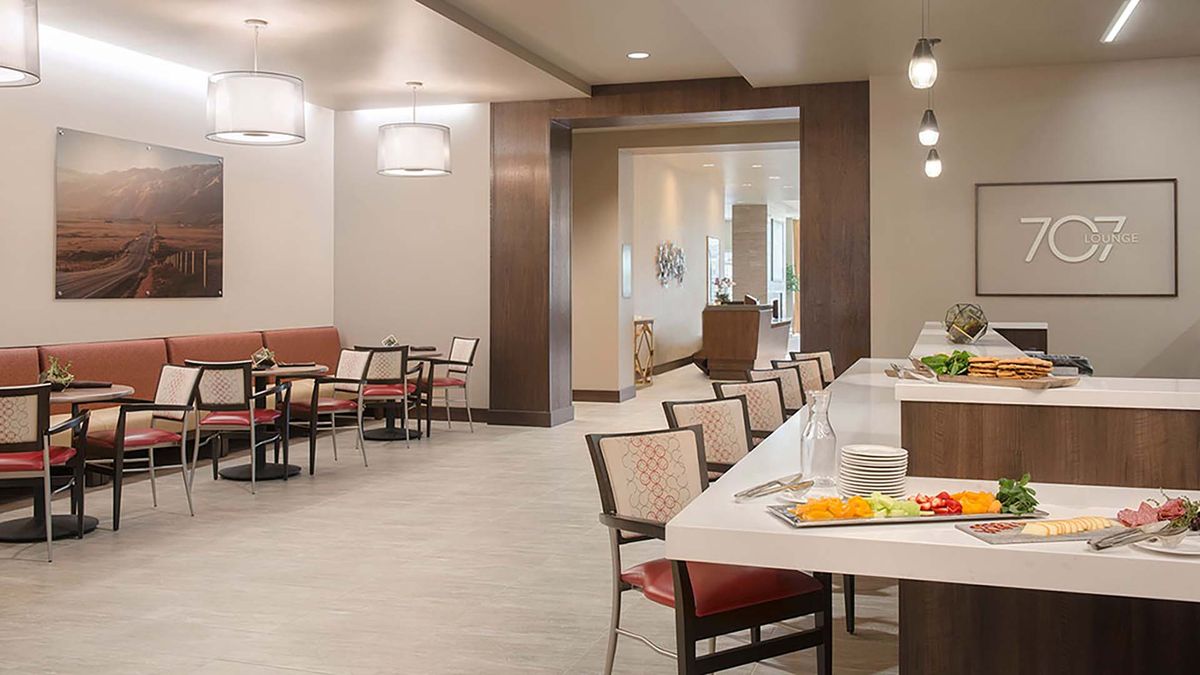 A modern dining area with neatly arranged seating and stylish lighting.