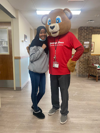 A fun moment captured with a mascot in a hospital setting.