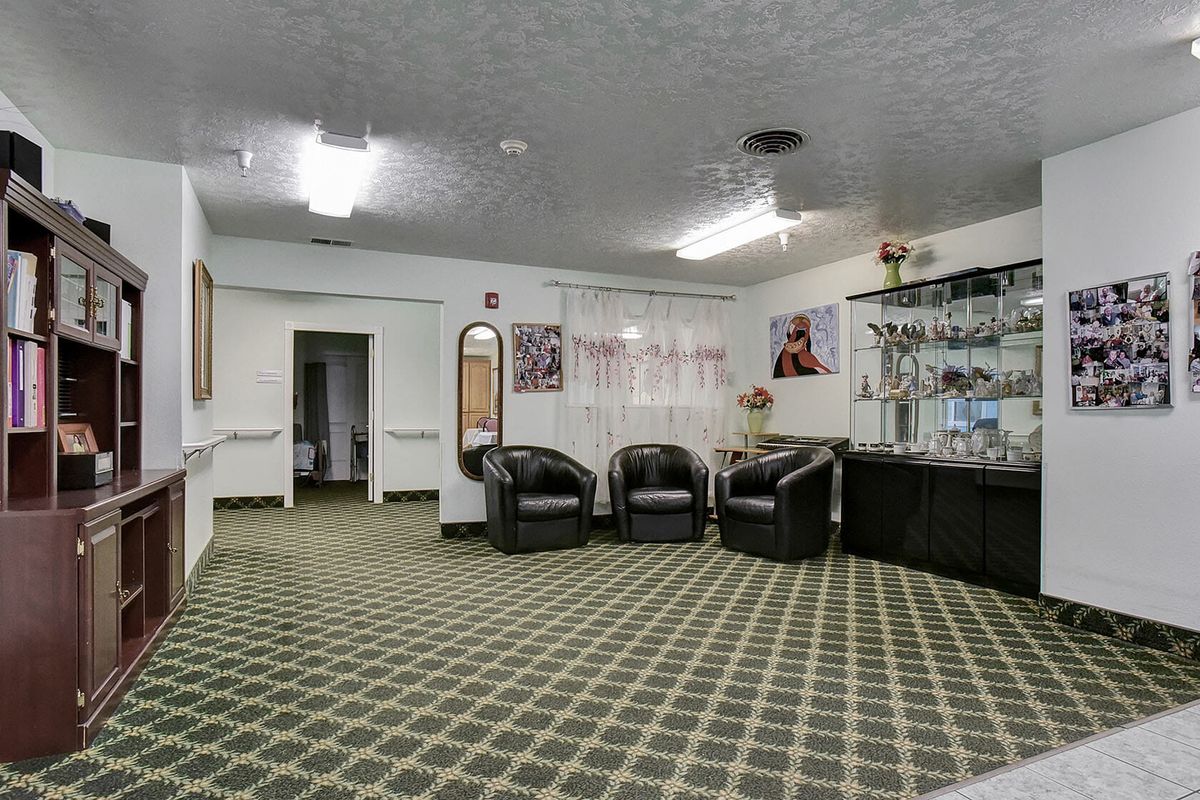 A modern lobby with comfortable seating and a bar counter.