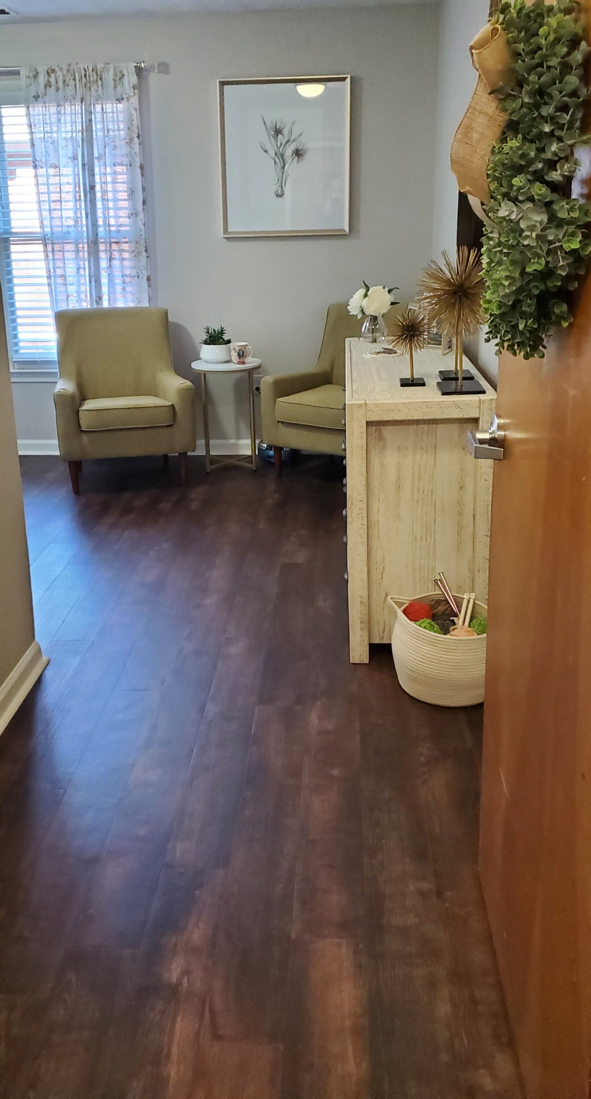 A cozy waiting room with armchairs, a small table, and decorative elements.