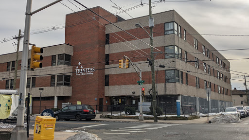 A modern urban building viewed from the street, showcasing contemporary architecture.