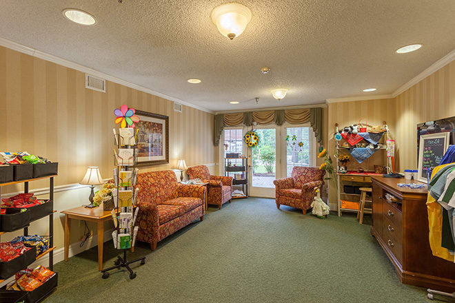 A cozy living room with sofas, armchairs, and warm lighting.