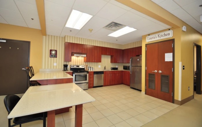 A modern kitchen with wooden cabinets and stainless steel appliances.