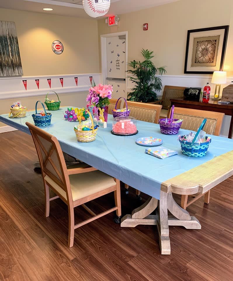 A dining room table set with colorful baskets and decorations, ready for a festive gathering.
