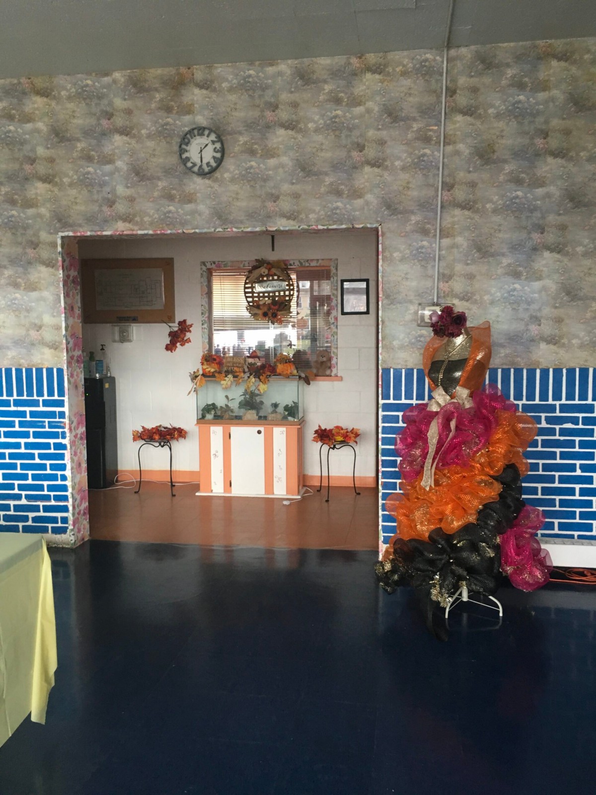 A cozy interior with autumn-themed decorations and a wall clock.