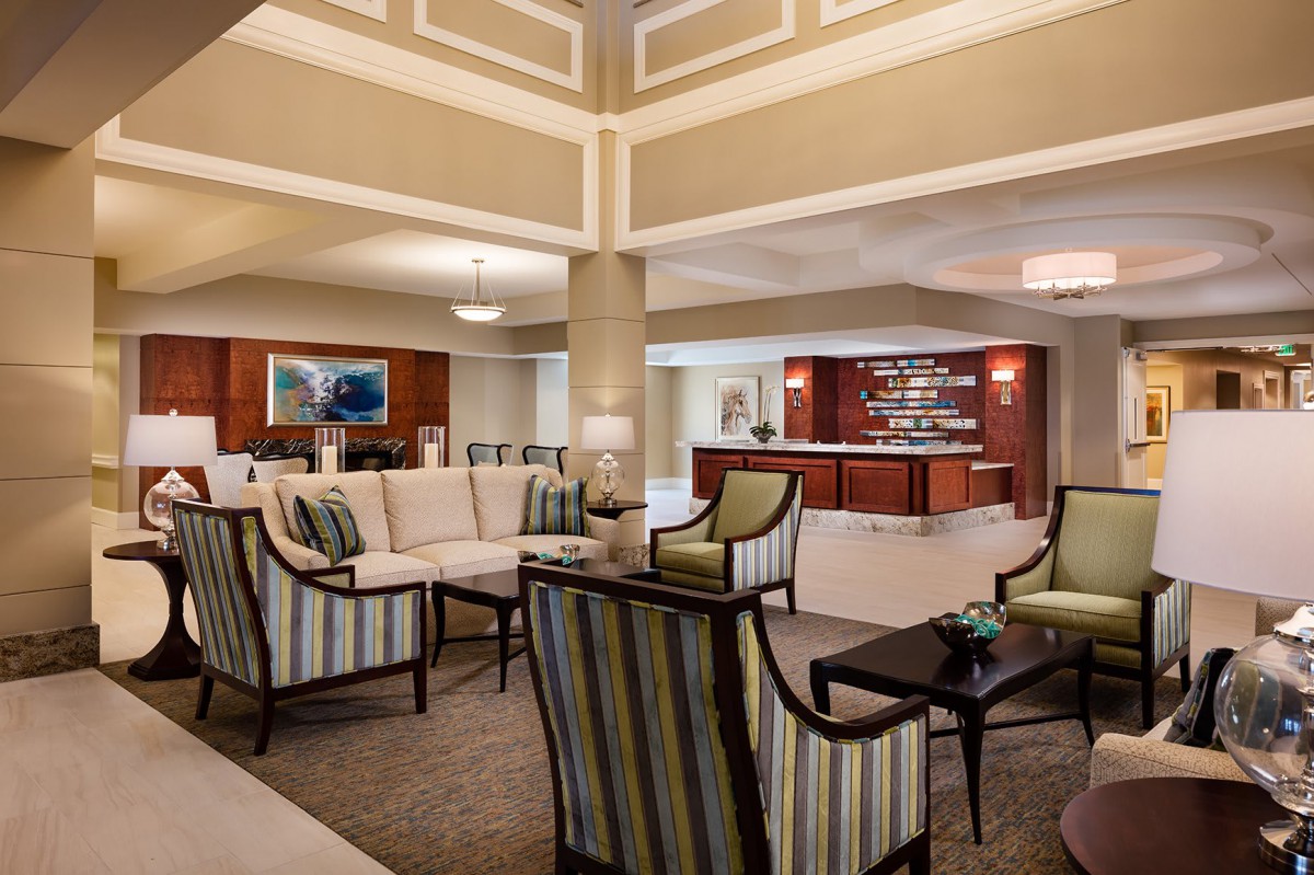 A modern hotel lobby with elegant seating and a reception desk.