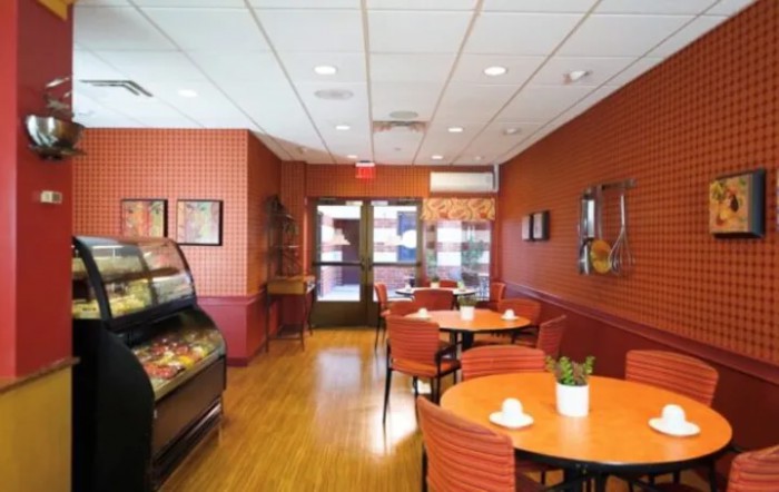 A cozy cafe interior with tables and chairs arranged for dining.