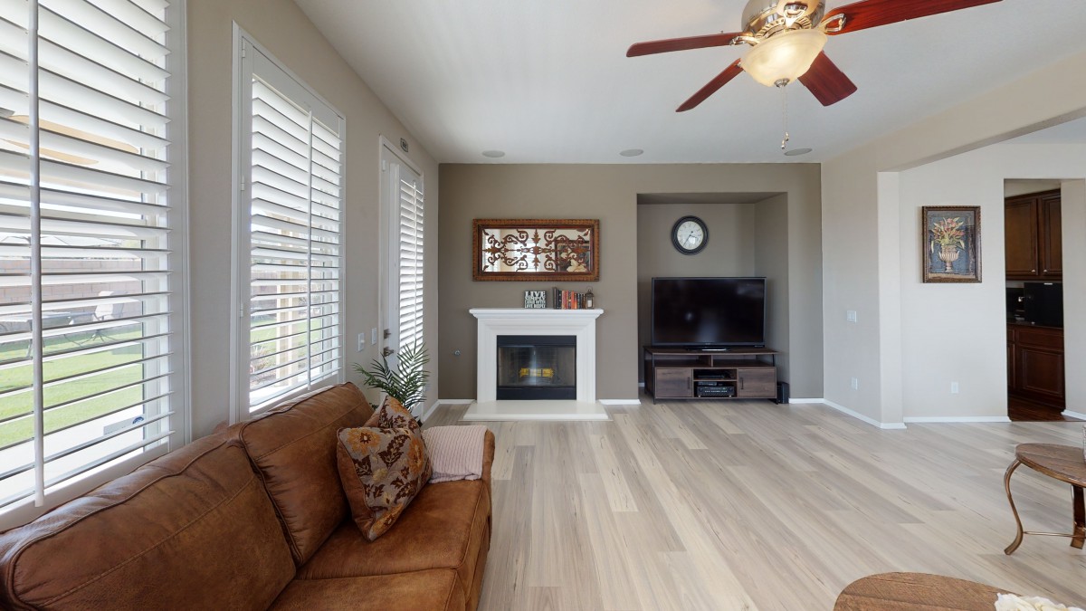 A cozy living room with a fireplace, television, and sofa.