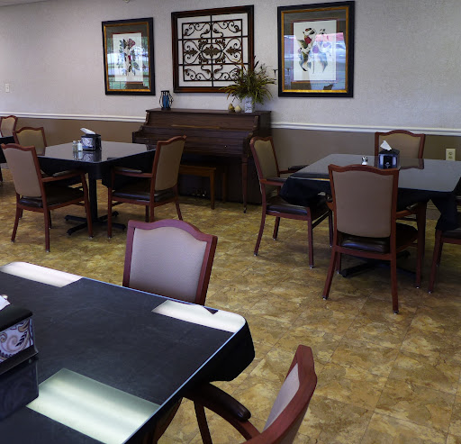 A spacious dining area featuring tables and chairs, with decorative elements on the walls.