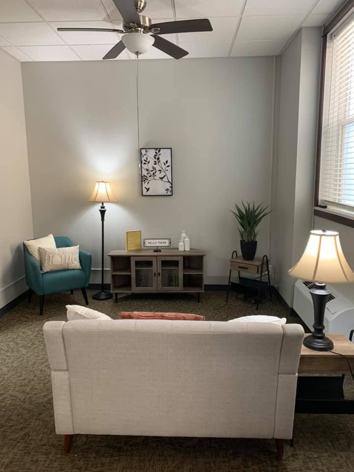 A cozy living room with comfortable seating and warm lighting.