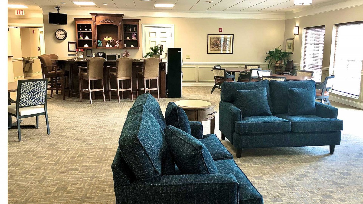 A cozy living room featuring comfortable sofas and a bar area.