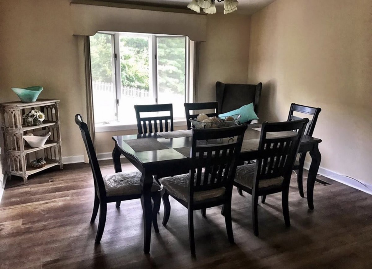 A cozy dining room with a large table and chairs near a bright window.